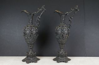 Pair of Renaissance style cast-bronze ewers, ornately decorated with Bacchanalian scenes, approx