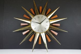 Mid 20th C Metamec brass & teak sunburst wall clock, the silvered dial with applied Arabic numerals.