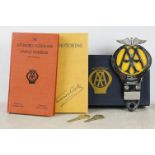 A vintage AA members box to include car grill badge, book and keys.