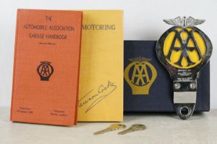 A vintage AA members box to include car grill badge, book and keys.