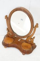 Victorian Walnut Framed Oval Swing Dressing Mirror, the platform base with two hinged lid