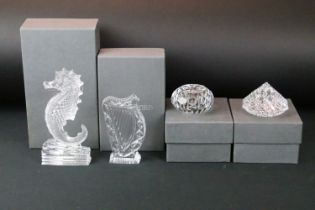 Four Waterford crystal boxed cut glass paperweights and ornaments to include a sea horse ornament,