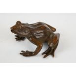 A cast bronze figure of a frog, approx 6cm in length.