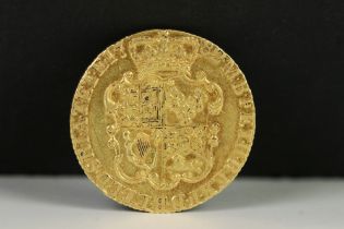 A British King George III 1782 gold full guinea coin.