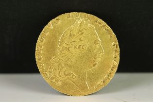 A British King George III 1795 gold full guinea coin.