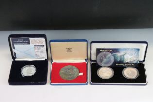 A Collection Of Three Cased Silver Coins To Include A Britannia £2 Coin, A 25th Anniversary Of The