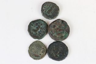 A collection of five early Roman bronze coins.
