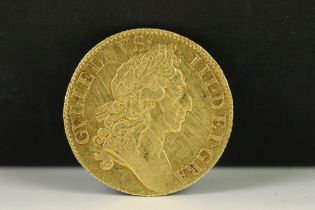 A British King William III 1701 gold full guinea coin.