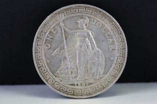 A British 1907 silver One Trade Dollar Coin.
