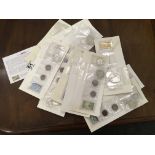 Collection of 13 folders each containing an American stamp and a collection of 5 American coins,