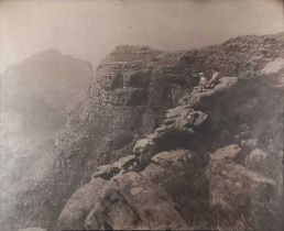Early 20th Century Black and White photograph of two figures sitting on top of a cliffs, 15.5" x