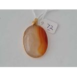 A large orange agate oval pendant 4cm long in heavy 18ct gold frame 18.8g inc