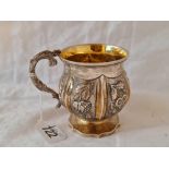 A parcel gilt Georgian Christening mug with embossed panels and Lizard shape cast handle, 3.5" high,