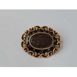 A Victorian Gold Memorial Brooch with Scroll Border Black Enamel & Woven Glazed Centre inscribed