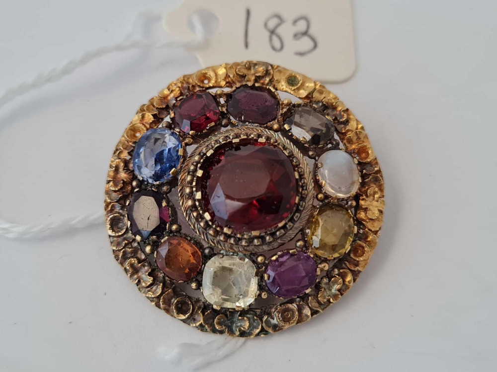 A antique circular brooch set with semi precious stones 9.4 gms