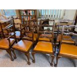 A set of eight (6 + 2) mahogany dining chairs with ladder backs and claw and ball feet