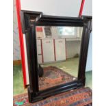 An ebonised 17th Century style mirror with moulded boarder