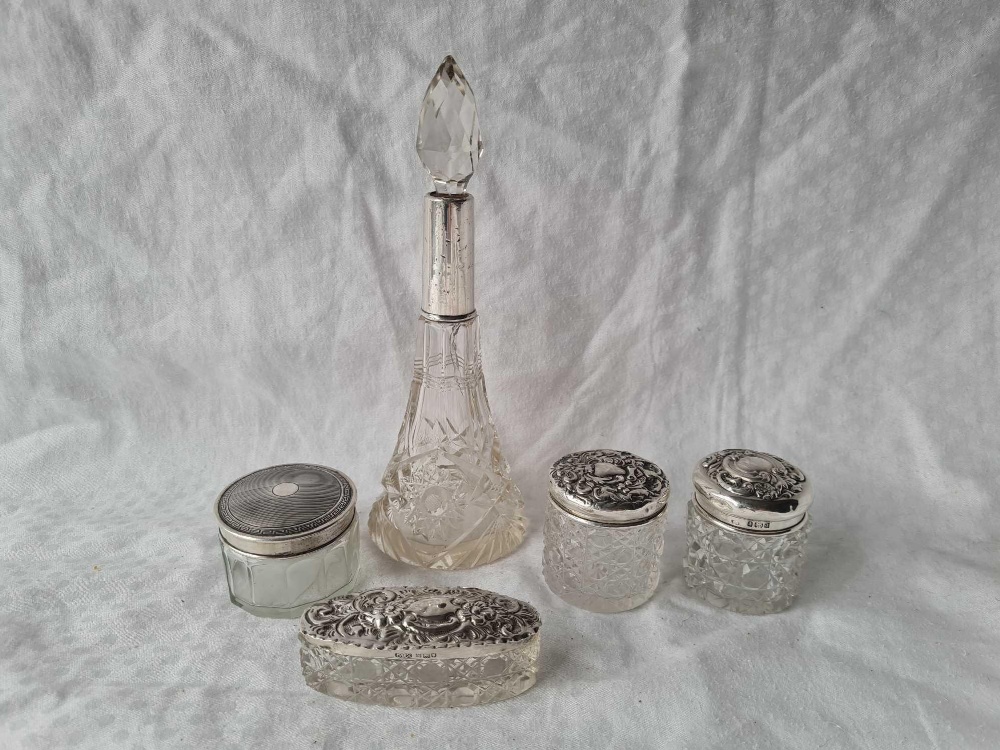 Four silver mounted jars and a scent bottle and stopper