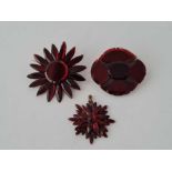 Two early Victorian red Vauxhall glass brooches and a pendant