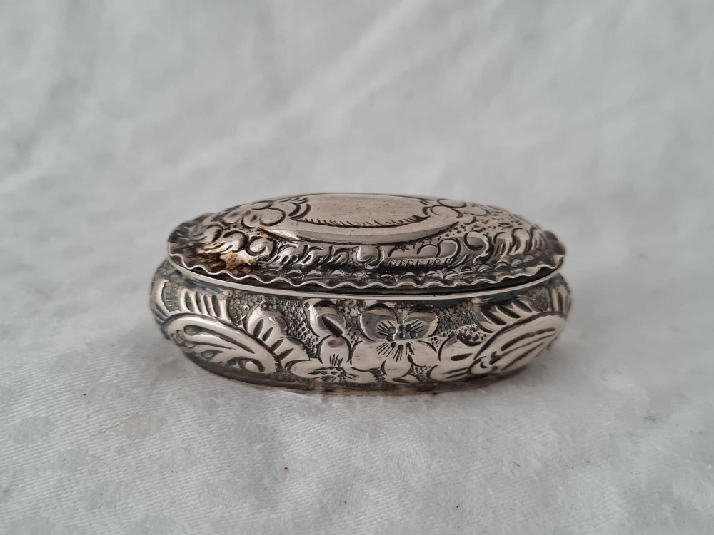 An oval pill boxed embossed, hinged cover, 2" wide, Birmingham 1897