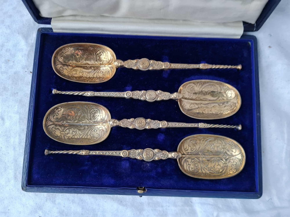 A set of four silver gilt coronation spoons with cast stems, London 1901