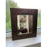 A hammered Arts and Crafts copper framed mirror, 16" wide