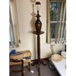 A mahogany pedestal with a lacquered lamp above