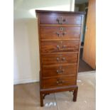 A narrow mahogany chest of six drawers on short stand, 18" wide