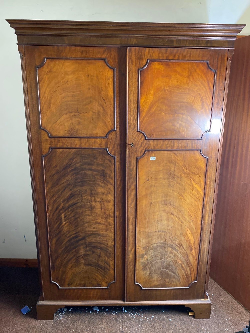 A George III , 4ft 3" wide style mahogany wardrobe with two panel doors, the interior with drawers