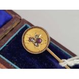 A cased gold stick pin with diamond & ruby stones in the form of a bee