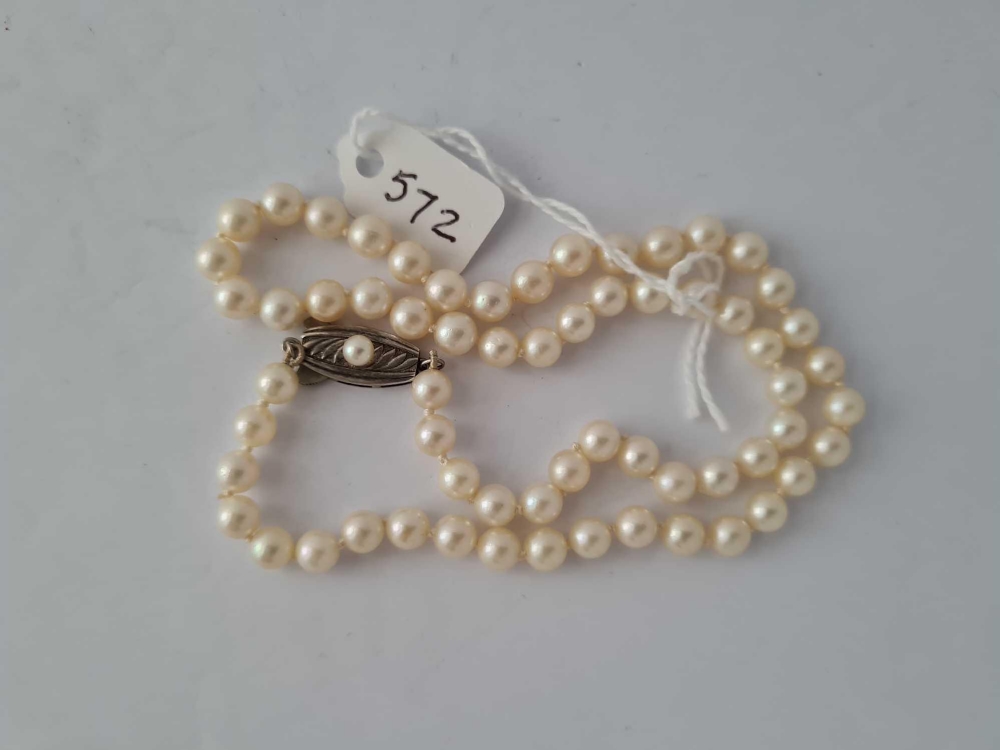 Cultured pearl necklace by Mikimoto signed with an ‘M’ on the silver clasp