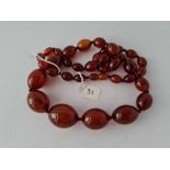 A string of Red Amber Graduated Oval Beads, 75g