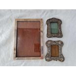 Two small embossed photo frames and another larger, foreign
