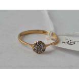 A diamond circular cluster ring in 18ct gold size R 1.8g inc