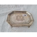 An octagonal George III tea pot stand with bright cut decoration, scroll feet, 6.5" wide, London