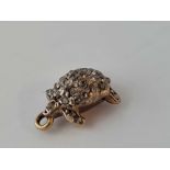 A unusual antique gold tortoise charm set with diamonds