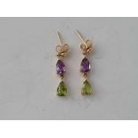 A pair of peridot & amethyst gold drop earrings