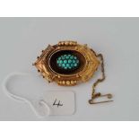 A attractive gold oval fancy brooch with turquoise cluster to centre