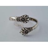 An antique stylised torque silver bangle