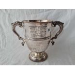 A good Victorian cup with leaf capped scroll handles, engraved Atherstone Hunt 1885, 8.5" high,