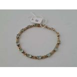 A tennis bracelet set with topaz and diamonds 9ct 8 inch 8.2 gms