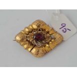 A Victorian diamond shaped gold brooch set with garnets 5gms