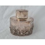 A decorative tea caddy with pull off cover and embossed with dancing figures, 3 1/4" wide,
