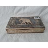 A Middle Eastern Niello cigarette box with hinged cover decorated with an elephant, (silver base),
