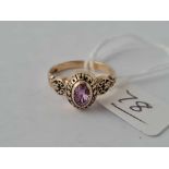 A small ladies 10k college ring set with pink sapphire or tourmaline size J 3g inc