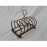 A heavy Victorian seven bar toast rack on ball feet, 6.5" wide, London 1889 by TWD, 365g