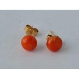 A pair of antique coral ear studs set with gold posts