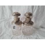 A pair of Victorian silver mounted scent bottles with cut glass bodies and stoppers, 5"high,
