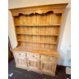 Reproduction pine dresser with cupboards, drawers and shelves. 5' wide, 6'8" high
