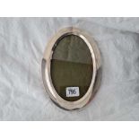 An oval photo frame with easel shaped back, 8.5" high, Birmingham 1921